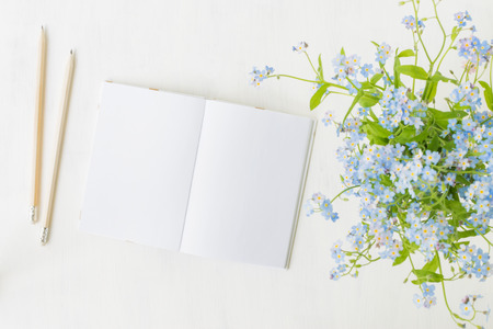 Mockup notebook with blue flowers and light backgroundの写真素材