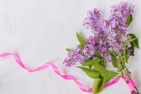 Lilac branches and pink ribbon on a light background empty space for your text, top viewの写真素材