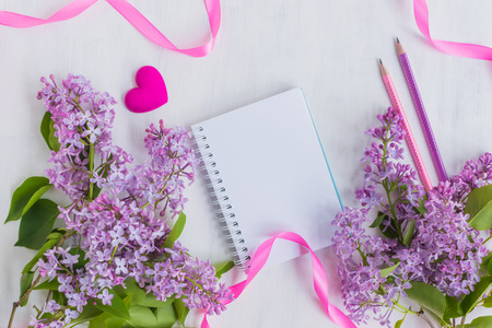 Mockup notebook with lilac branches and light background empty space for your text, top viewの写真素材