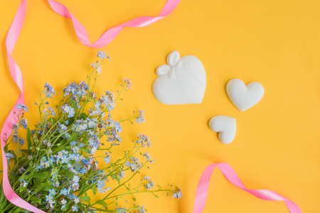 Blue flowers on a yellow background empty space for your text, top viewの写真素材