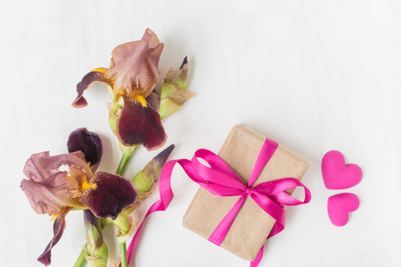 Gift box with iris flower on white backgroundの写真素材