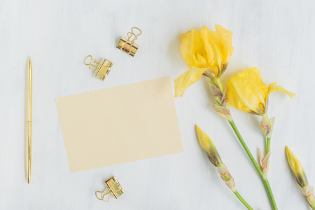 Mockup light yellow greeting card with iris flowers and light backgroundの写真素材