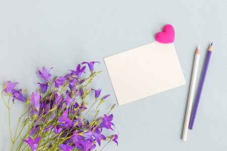 Mockup white greeting card with summer flowers and light backgroundの写真素材