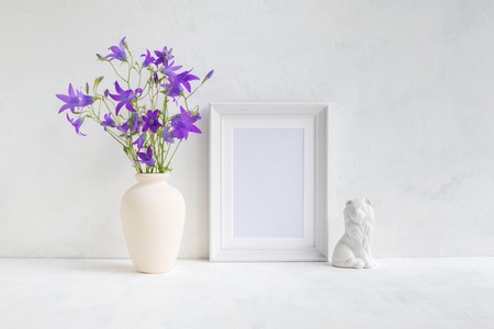 Home interior with decor elements. White frame, flowers in a vase, interior decorationの写真素材
