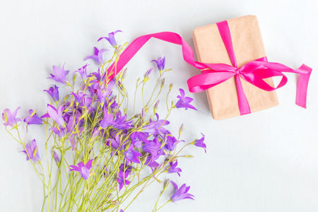 Gift box with summer flowers on a light blue backgroundの写真素材