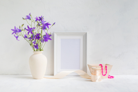 Home interior with decor elements. White frame, flowers in a vase, interior decorationの写真素材