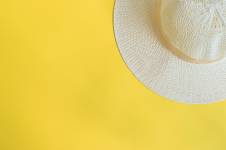 Summer hat on a yellow background. Top view, flat layの写真素材