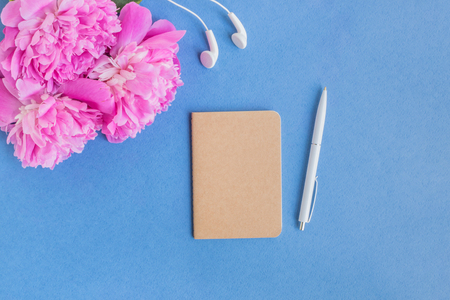 Mockup notebook with pink peonies on a blue backgroundの写真素材