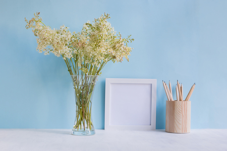 Home interior with decor elements. White frame, flowers in a vase, interior decorationの写真素材