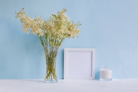 Home interior with decor elements. White frame, flowers in a vase, interior decorationの写真素材