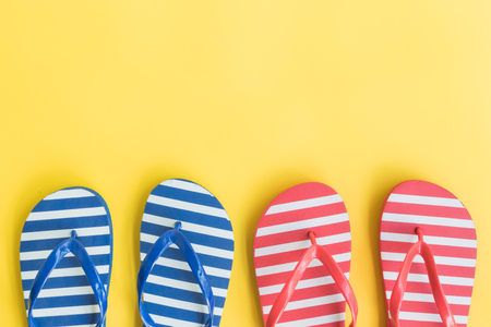 Flip flops on a yellow background. Top view, flat layの写真素材