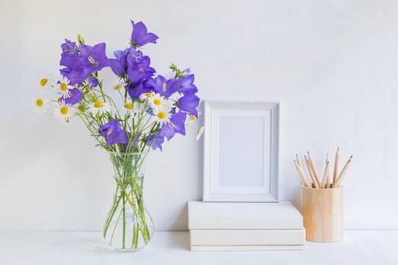Home interior with decor elements. White frame, flowers in a vase, interior decorationの写真素材
