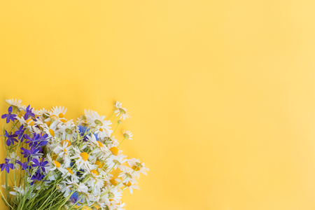 Bouquet of summer flowers on a yellow background. Top view, flat layの写真素材