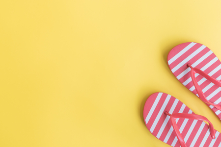 Flip flops on a yellow background. Top view, flat layの写真素材