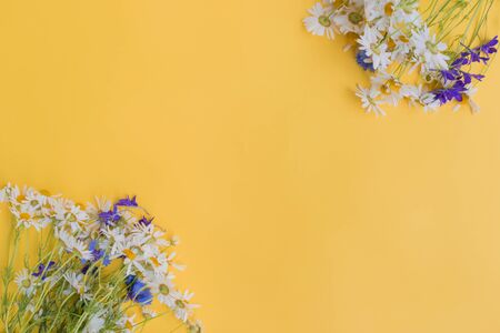 Bouquet of summer flowers on a yellow background. Top view, flat layの写真素材
