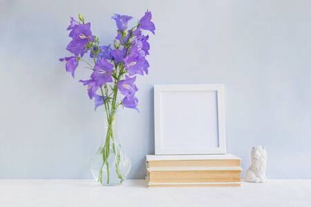 Home interior with decor elements. White frame, flowers in a vase, interior decorationの写真素材