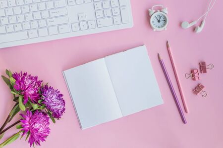 Mockup open notebook with pink flowers on pink backgroundの写真素材