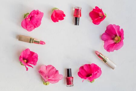 Flat lay pattern with pink flowers and female cosmetics. Beauty blog conceptの写真素材