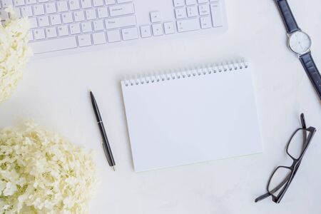 Mockup notebook with white flower hydrangea on light backgroundの写真素材