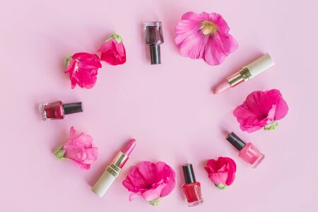 Flat lay pattern with pink flowers and female cosmetics. Beauty blog conceptの写真素材