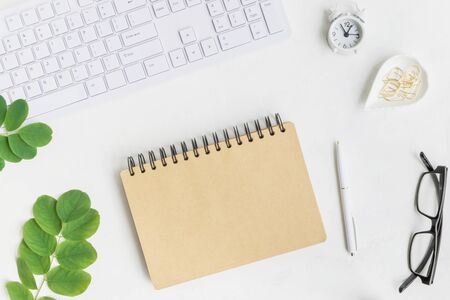 Mockup notebook with green leaves on light background