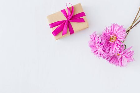 Pink flowers with gift box on white background empty space for your text, top viewの写真素材