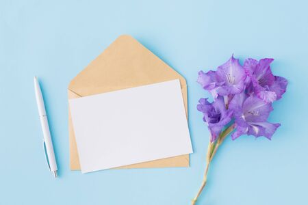 Mockup blank paper card and envelope on a blue background. Flat lay, top viewの写真素材