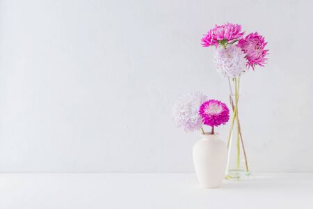 Pink flowers in a vase on a light background. Interior decorの写真素材