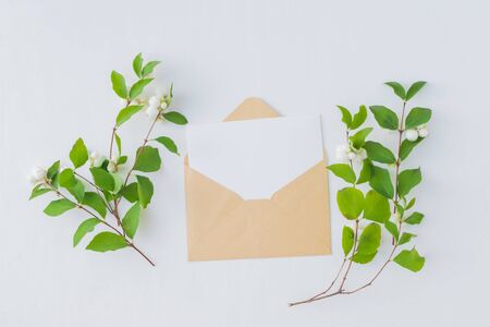 Mockup blank paper card and envelope on a white background. Flat lay, top viewの写真素材