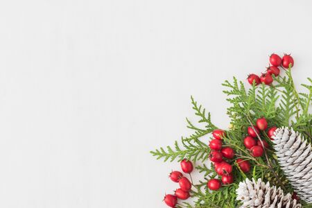Holiday background with christmas branches and decoration on a light background