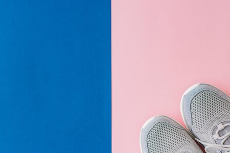 Concept of healthy lifestyle. Flat lay sport shoes, new sneakers on pastel colored backgroundの写真素材