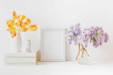 Home interior with decor elements. White frame, branches of lilac in a vase, interior decorationの写真素材
