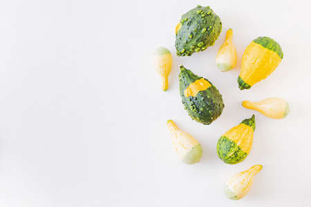 Flat lay pattern with pumpkins on a white background