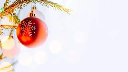 Holiday border with hanging christmas tree ball decorations on a light backgroundの写真素材