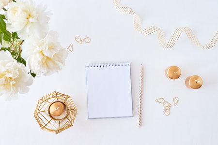 Mockup white notebook with white peonies on a white backgroundの写真素材
