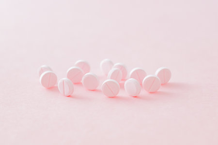 Pink pills on a pink background. Medical pharmacy conceptの写真素材