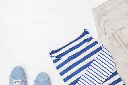 Flat lay female fashion look with stylish clothes and accessories on a light background