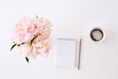 Mockup white notebook with pink peonies on a white backgroundの写真素材
