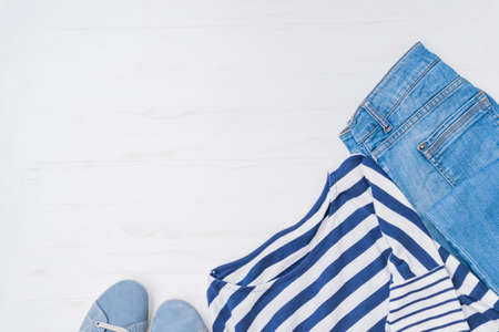 Flat lay female fashion look with stylish clothes and accessories on a light backgroundの写真素材
