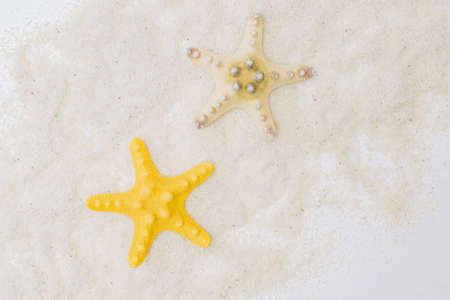 Flat lay composition with color starfish and sandの写真素材