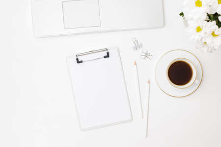 Mockup clipboard, laptop and cup of coffee on a white backgroundの写真素材