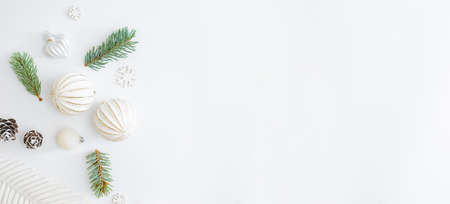 Flat lay frame with fir branches and christmas balls on a white backgroundの写真素材