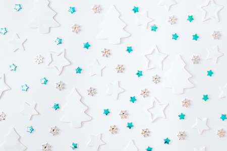 Flat lay pattern with stars, christmas baubles decoration and snowflakes on a white backgroundの写真素材