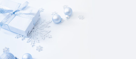 Frame with christmas baubles decoration and gift box on a white backgroundの写真素材