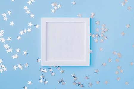 Mockup white frame with christmas decorationon a blue backgroundの写真素材