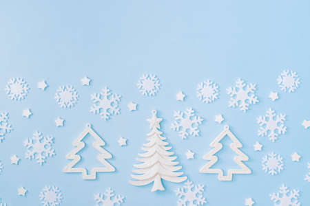 Flat lay border with christmas balls and snowflakes on a blue backgroundの写真素材