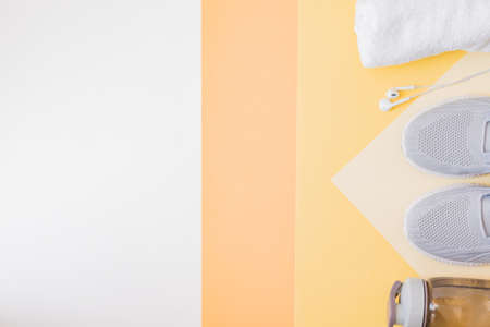 Concept of healthy lifestyle. Flat lay sport shoes, new sneakers on a yellow backgroundの写真素材