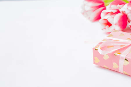 Valentines day composition with pink tulips and gift box on a white backgroundの写真素材