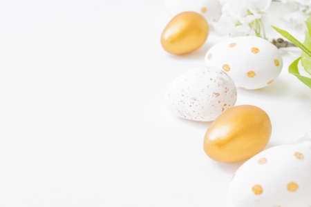 Easter composition with spring flowers and eggs on white background