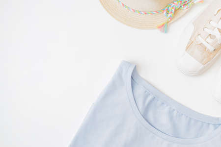Flat lay summer composition with straw hat and sneakers on a white backgroundの写真素材